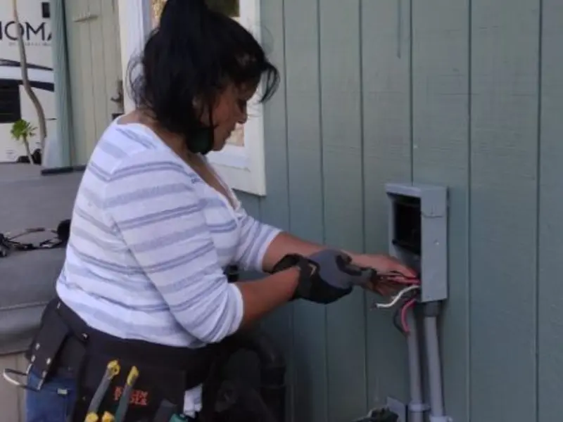 Licensed electrician wiring an exterior subpanel in Tulare